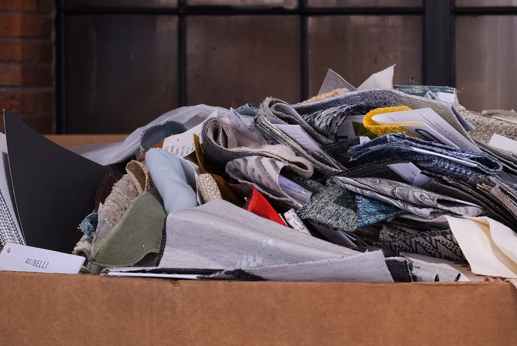 Box of material samples being sorted for reuse